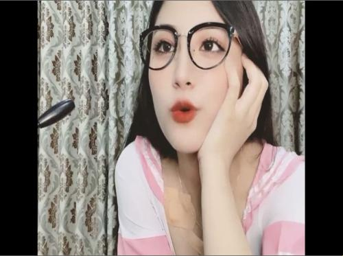 The girl in glasses shows off her big breasts